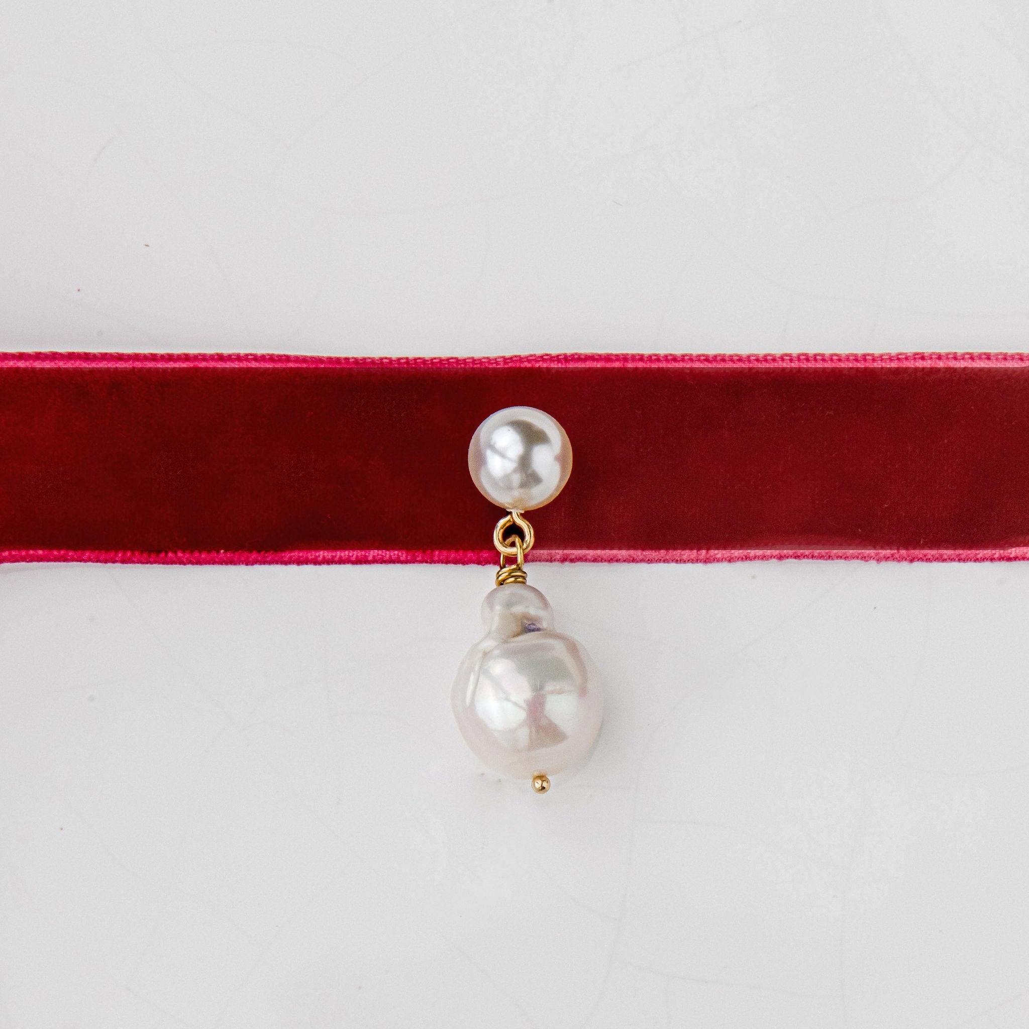 Velvet pearl choker with freshwater pearls and gold detail, tied in a bow for an adjustable fit