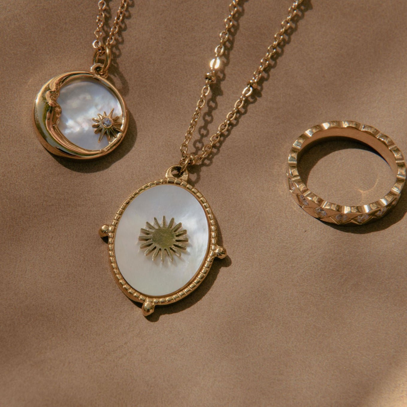 Gold moon and star pendant necklace with mother of pearl inlay and Cubic Zirconia detail on a waterproof chain