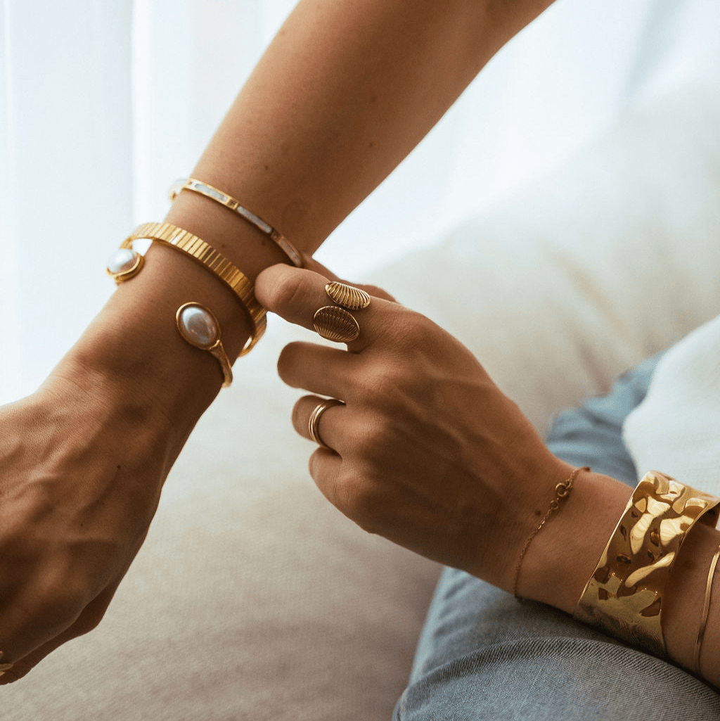 Textured gold cuff bangle with freshwater pearls on each end