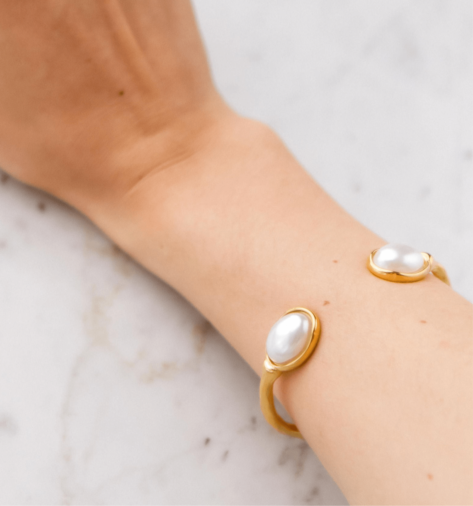 Textured gold cuff bangle with freshwater pearls on each end