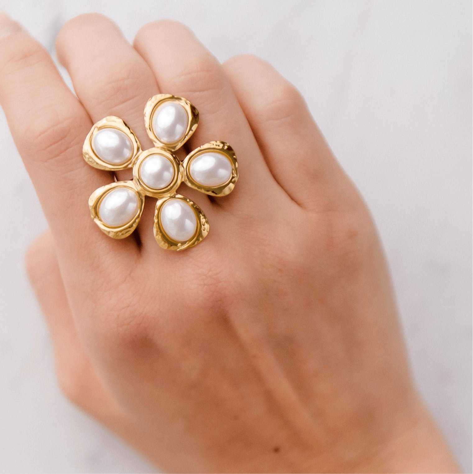 Gold floral statement ring with six freshwater pearls in a hammered setting