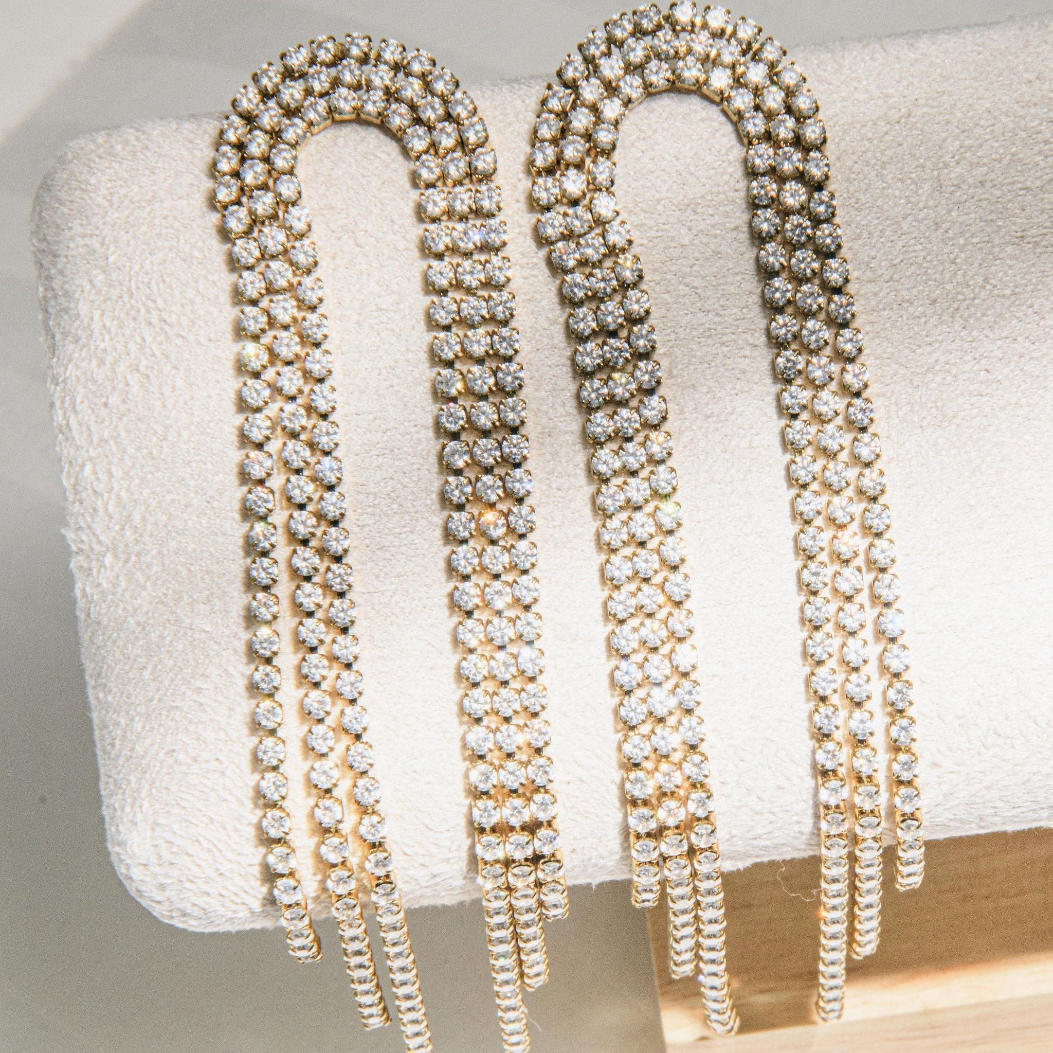 gold drop earrings with cascading cubic zirconia strands