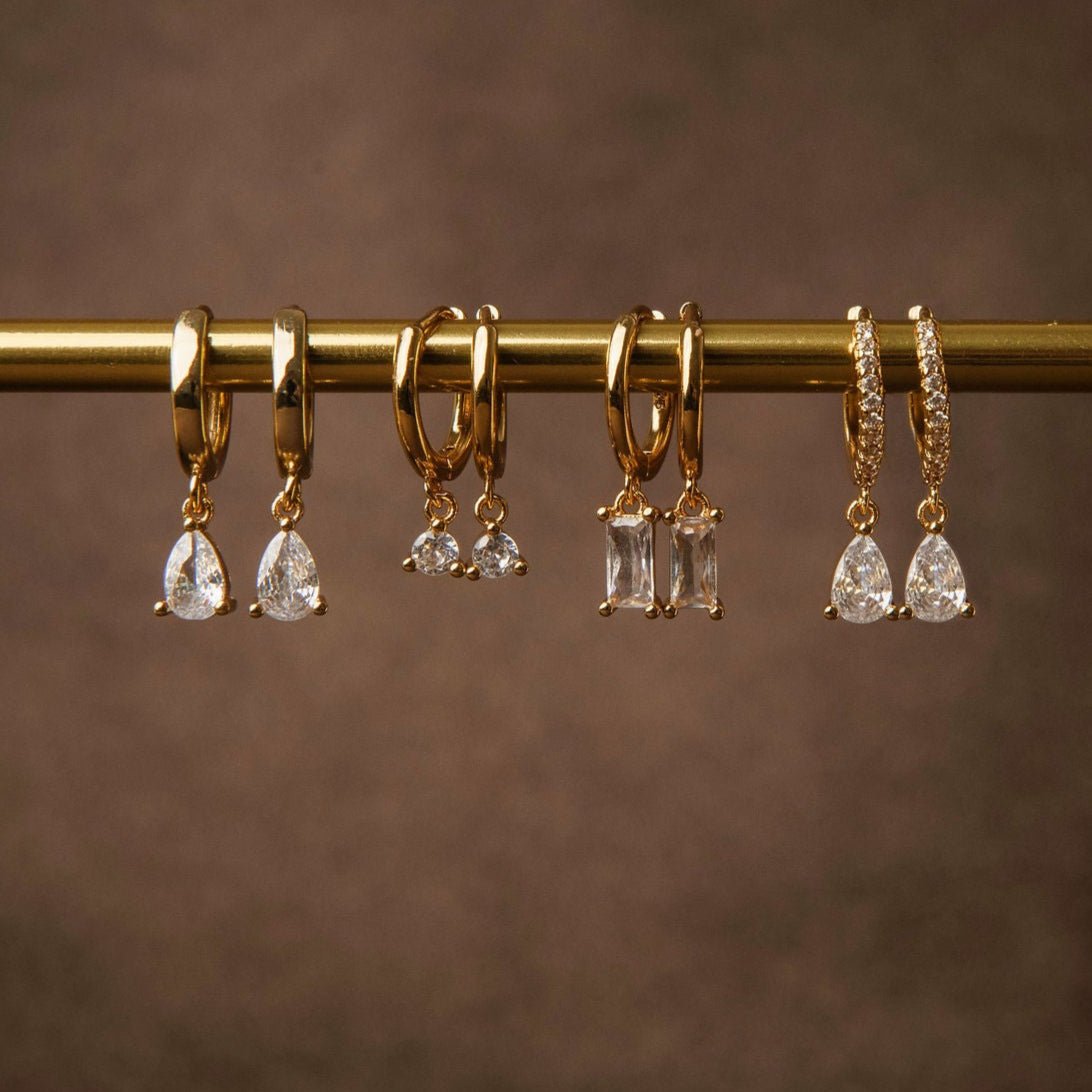 Gold huggie hoop earrings with pear-cut cubic zirconia drop
