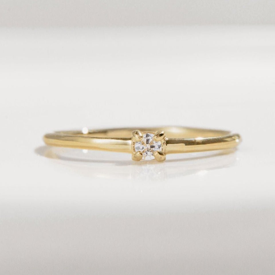 gold ring with single round Cubic Zirconia on a fine band