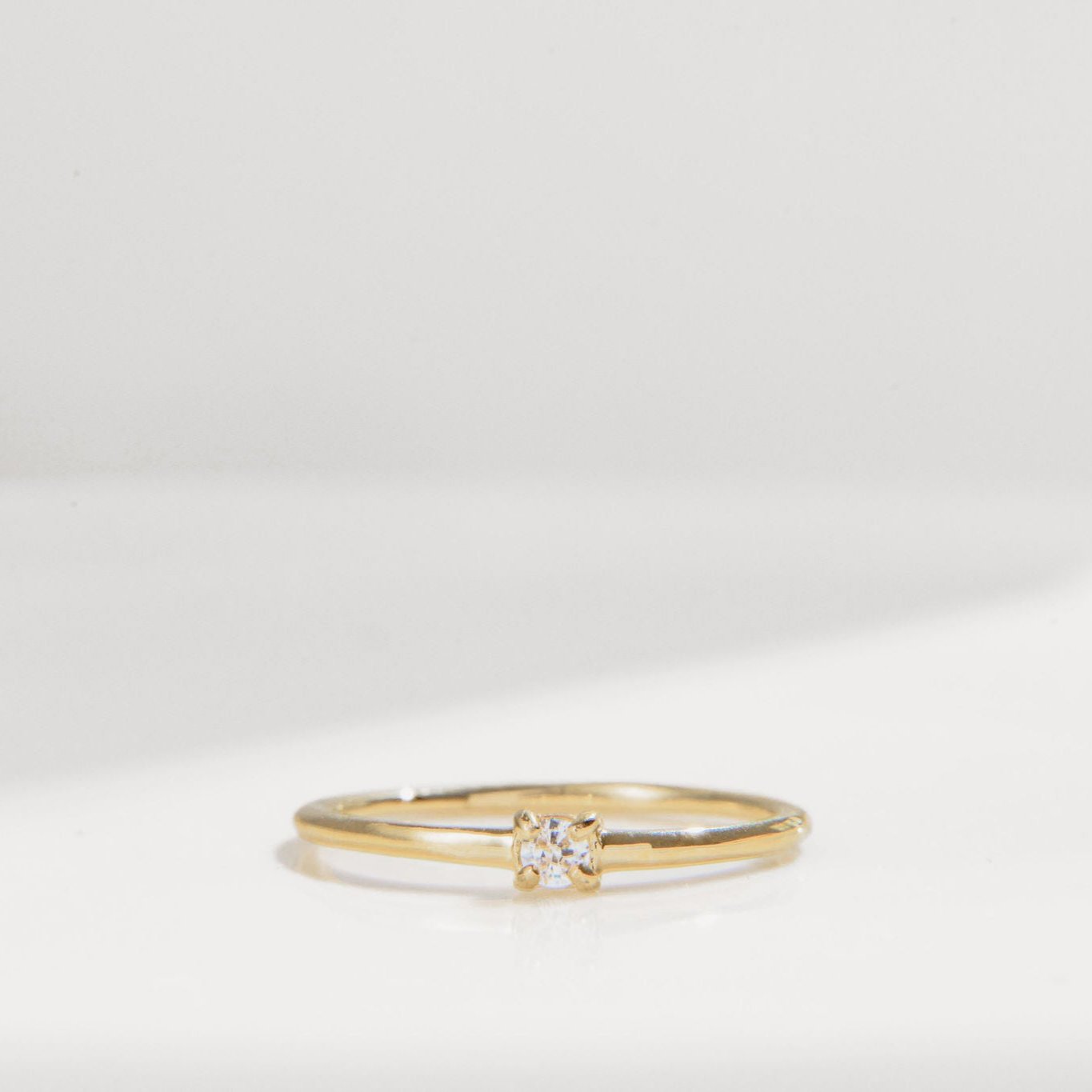 gold ring with single round Cubic Zirconia on a fine band