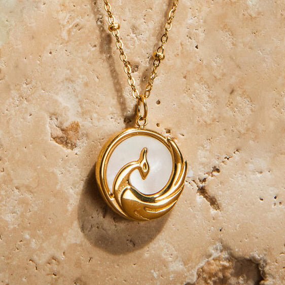 Gold phoenix pendant necklace on waterproof beaded chain symbolising rebirth and strength
