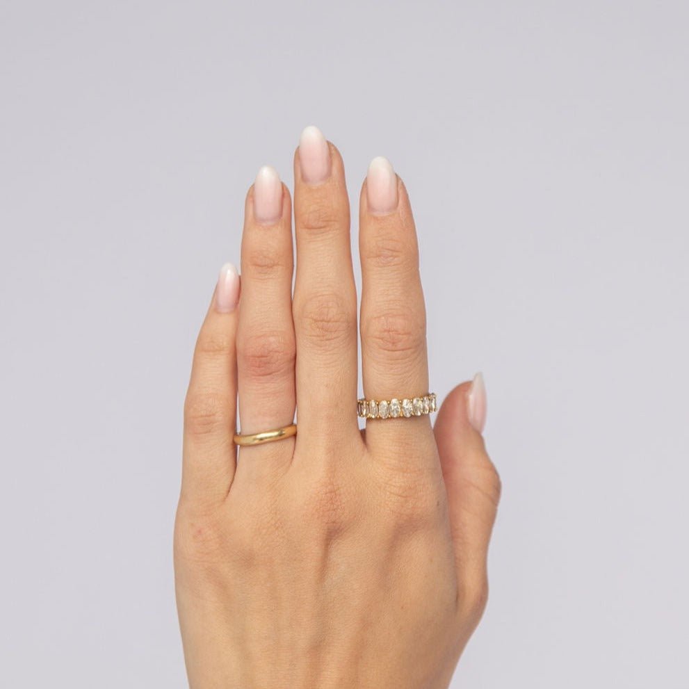 gold-plated ring with oval-cut cubic zirconia stones in a full circle setting