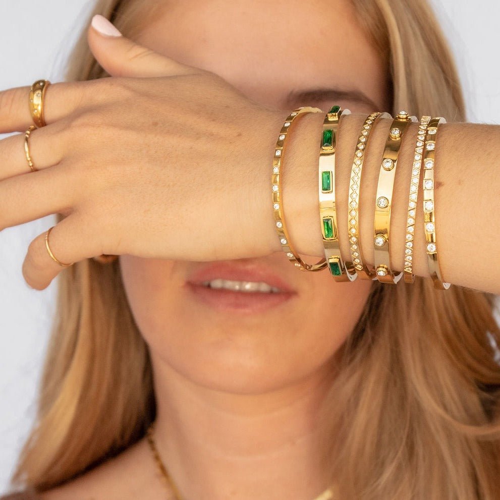 gold-plated bangle with diamond-cut pattern and cubic zirconia accents