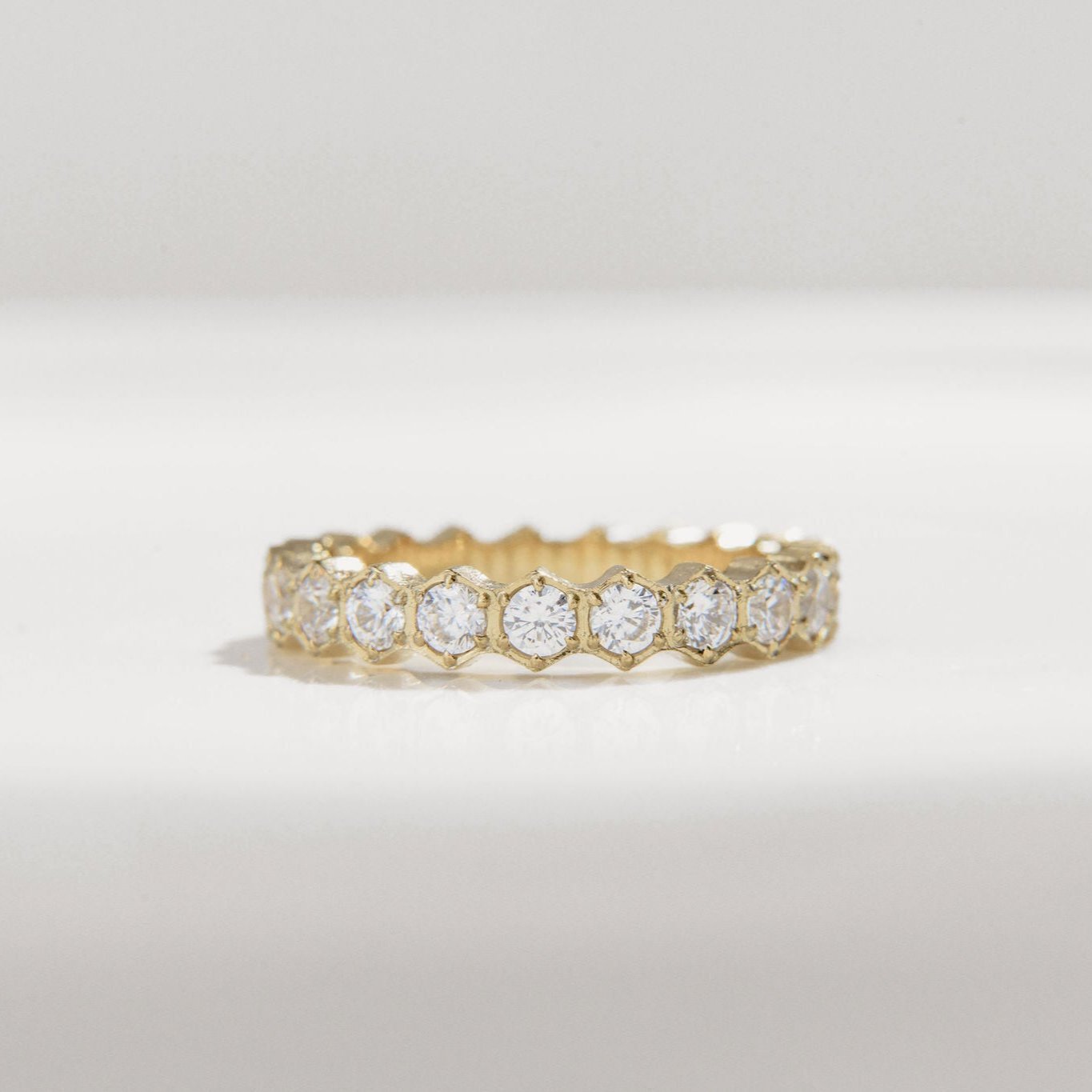 gold ring with scalloped band and round Cubic Zirconia stones