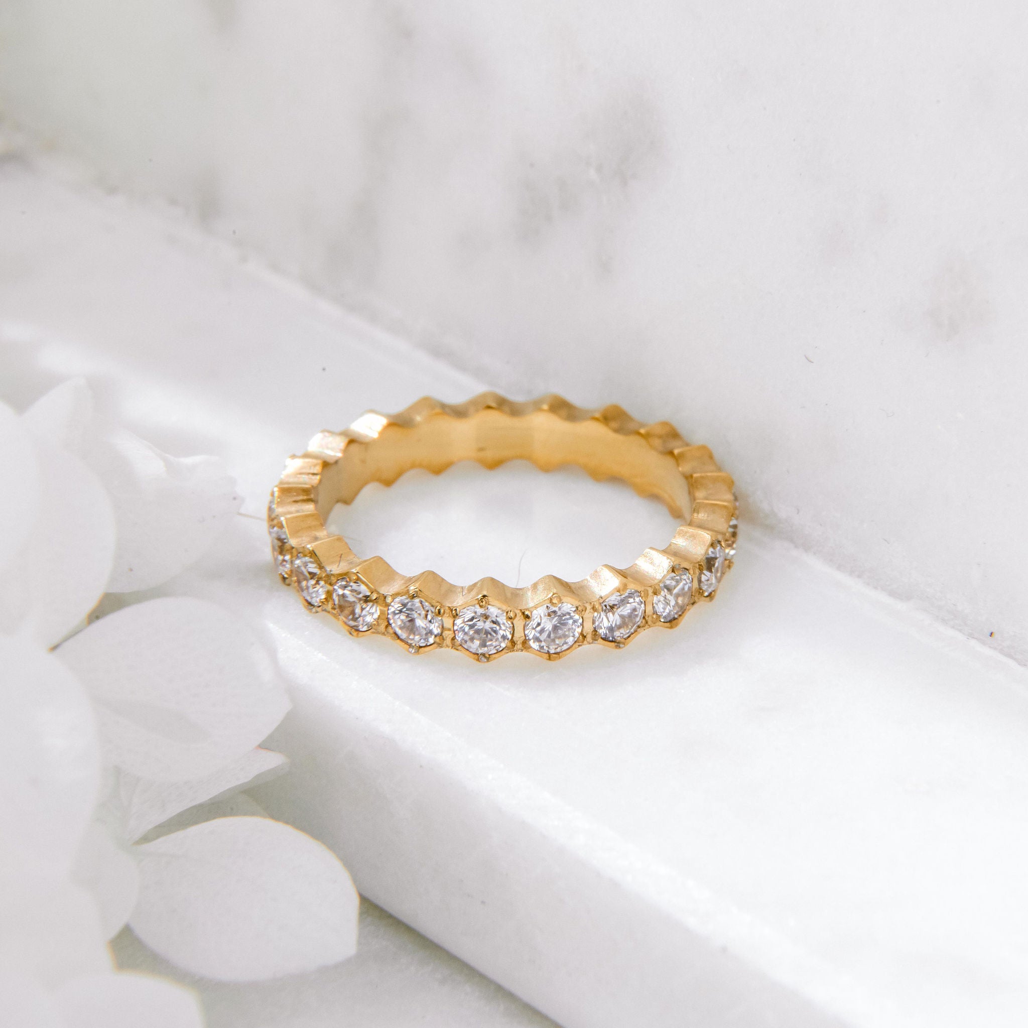 gold ring with scalloped band and round Cubic Zirconia stones