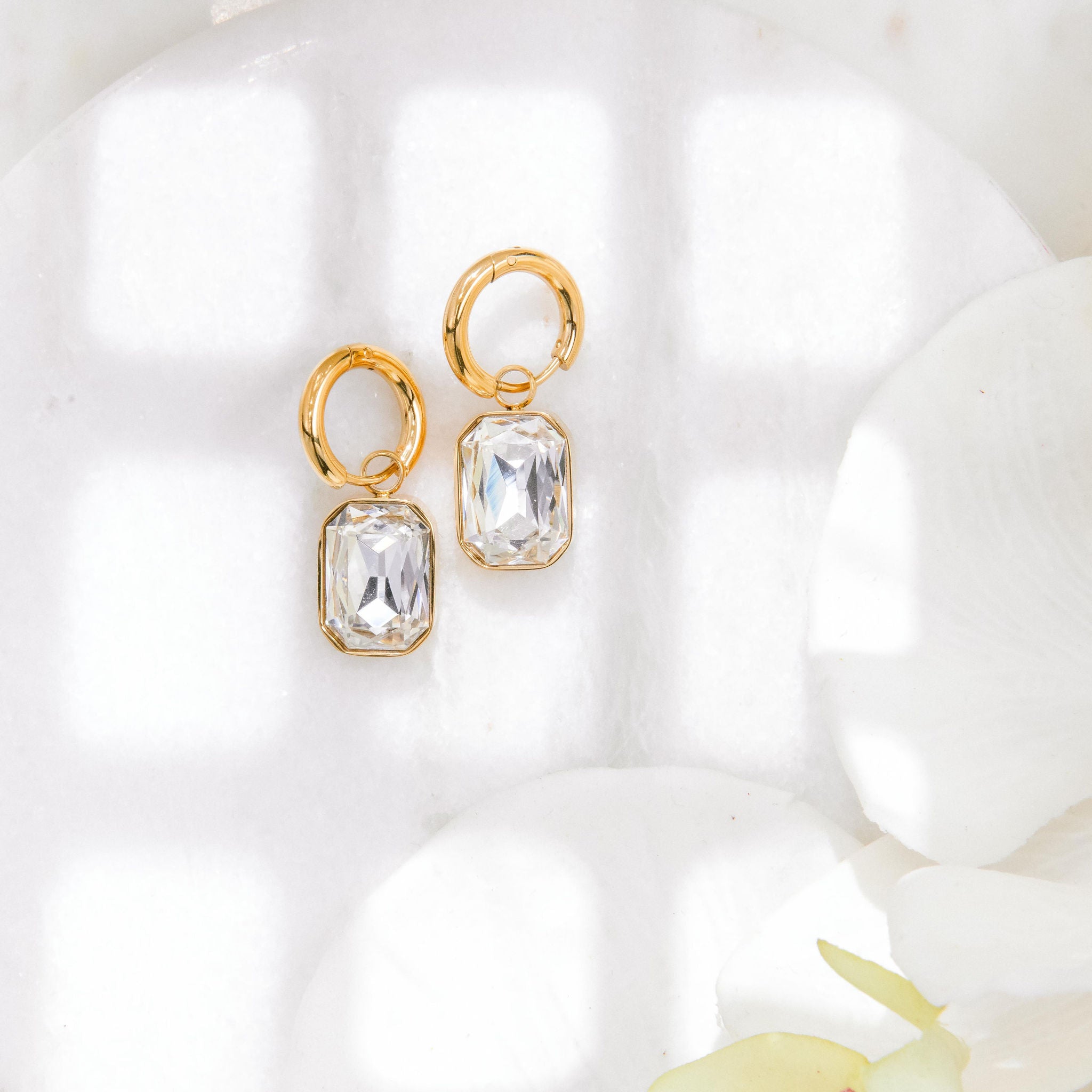 gold huggie hoop earrings with emerald-cut cubic zirconia