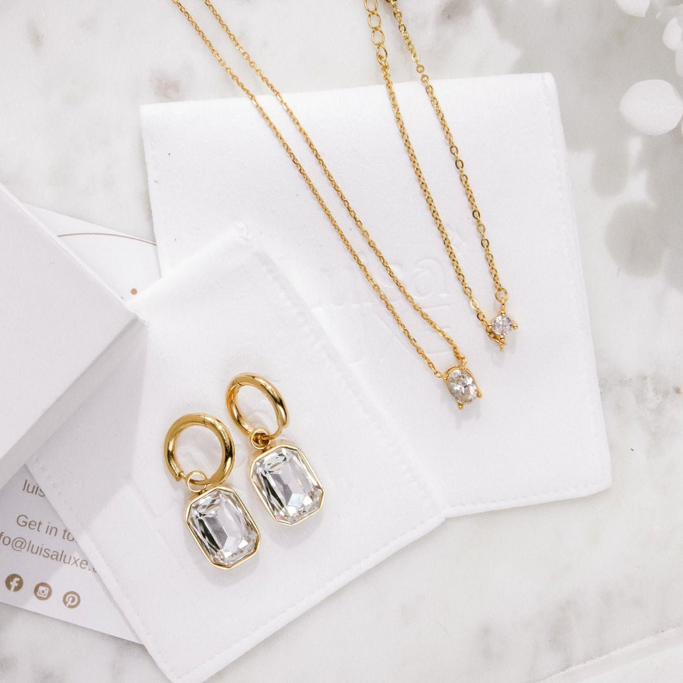 gold huggie hoop earrings with emerald-cut cubic zirconia