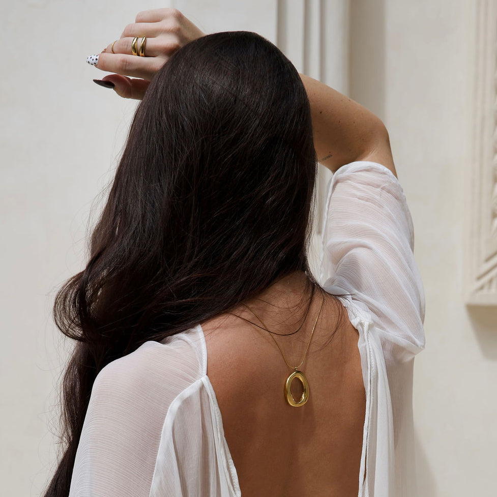 Kyra gold pendant necklace with a polished organic open-centre design