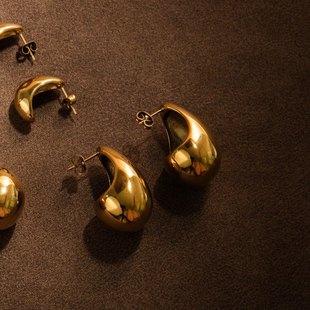 chunky gold stud earrings with sculptural teardrop shape