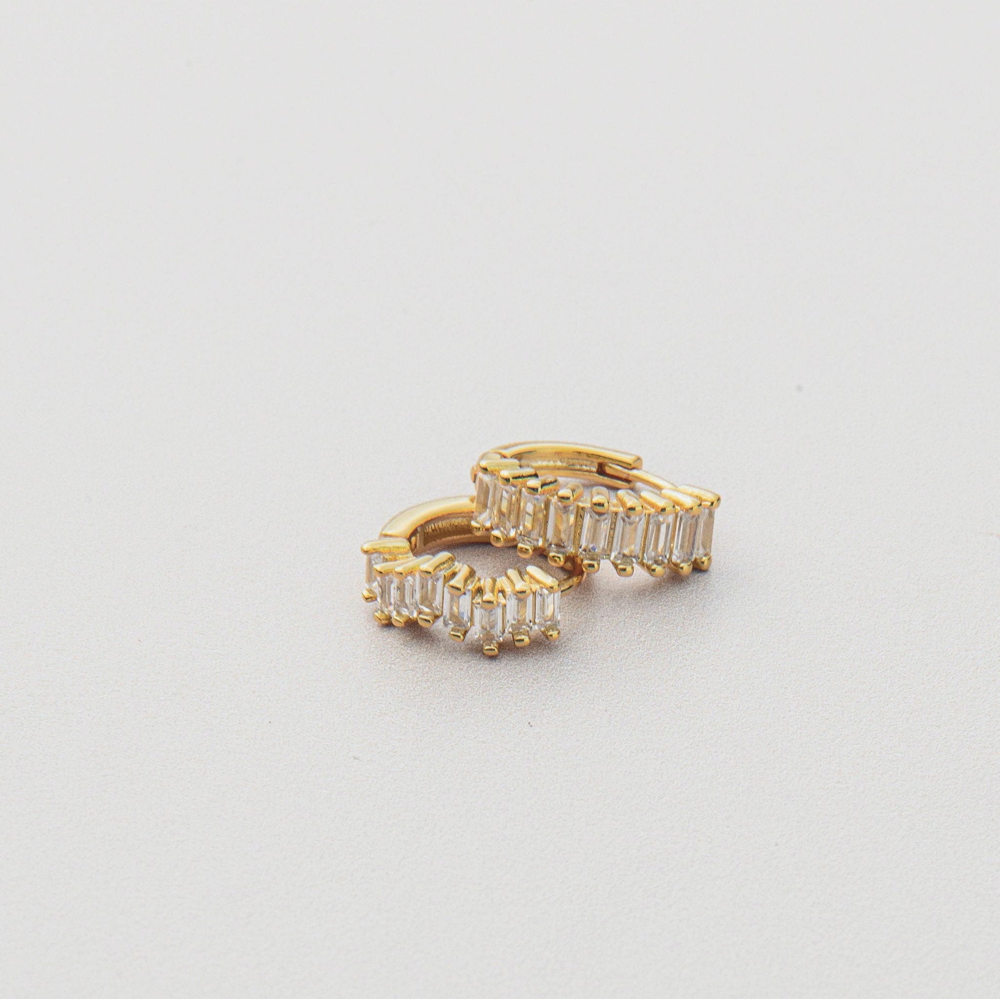 gold huggie earrings with baguette cubic zirconia stones