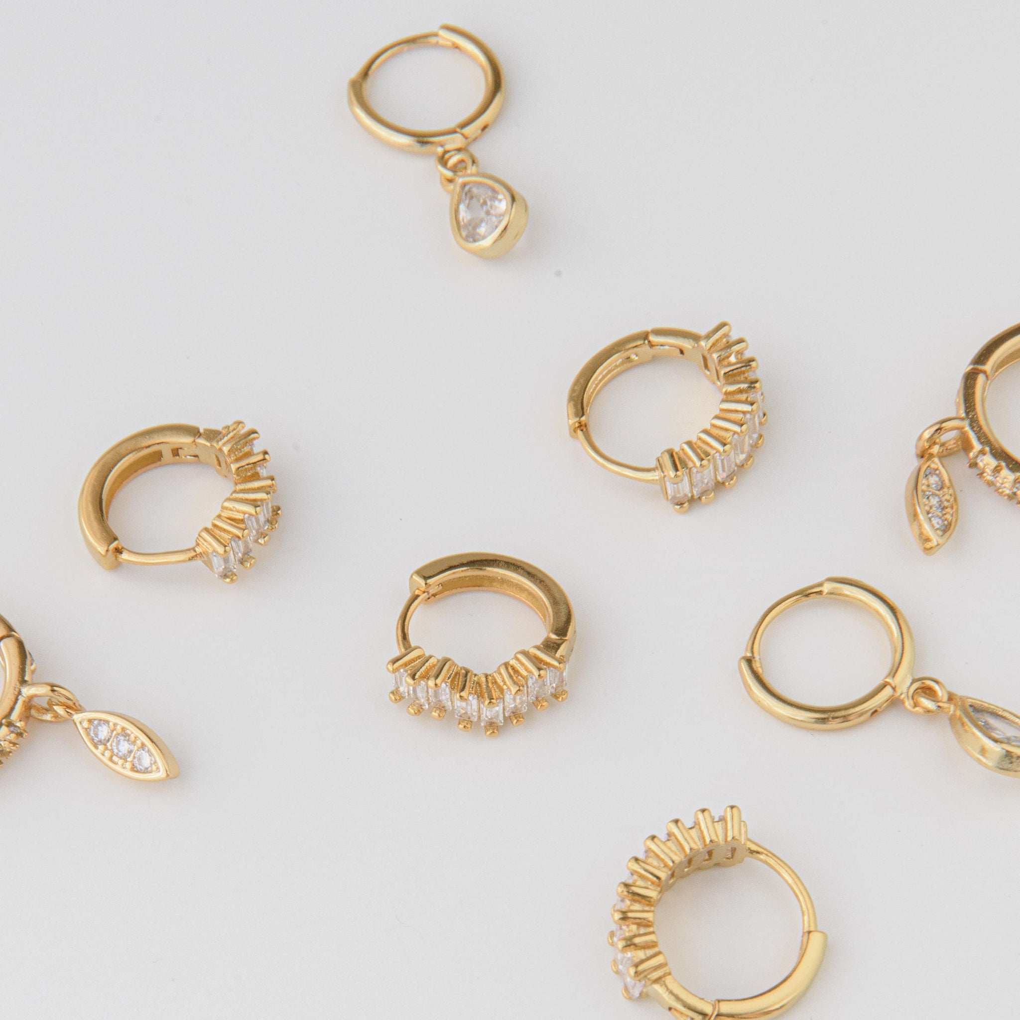 gold huggie earrings with baguette cubic zirconia stones