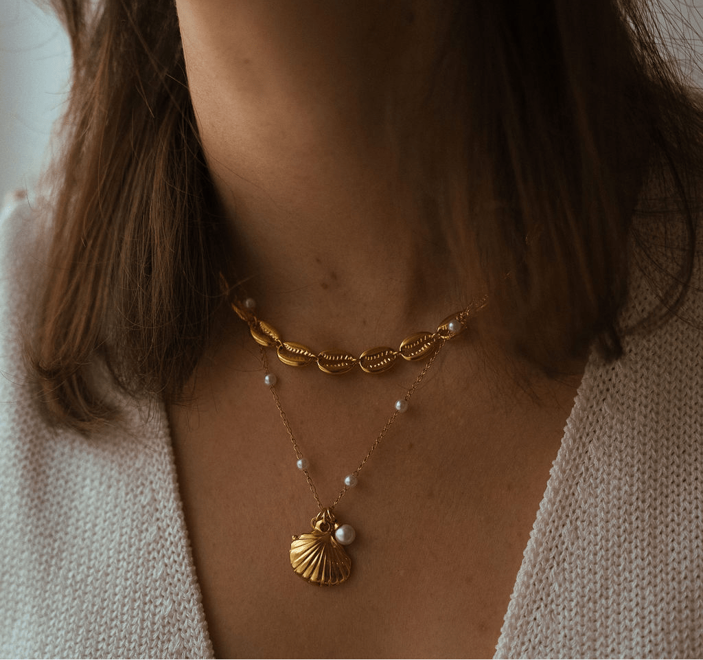 Marina Necklace with gold starfish and shell charms and freshwater pearl accents on a waterproof chain