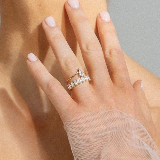 Pear-cut cubic zirconia stunt ring with curved gold band