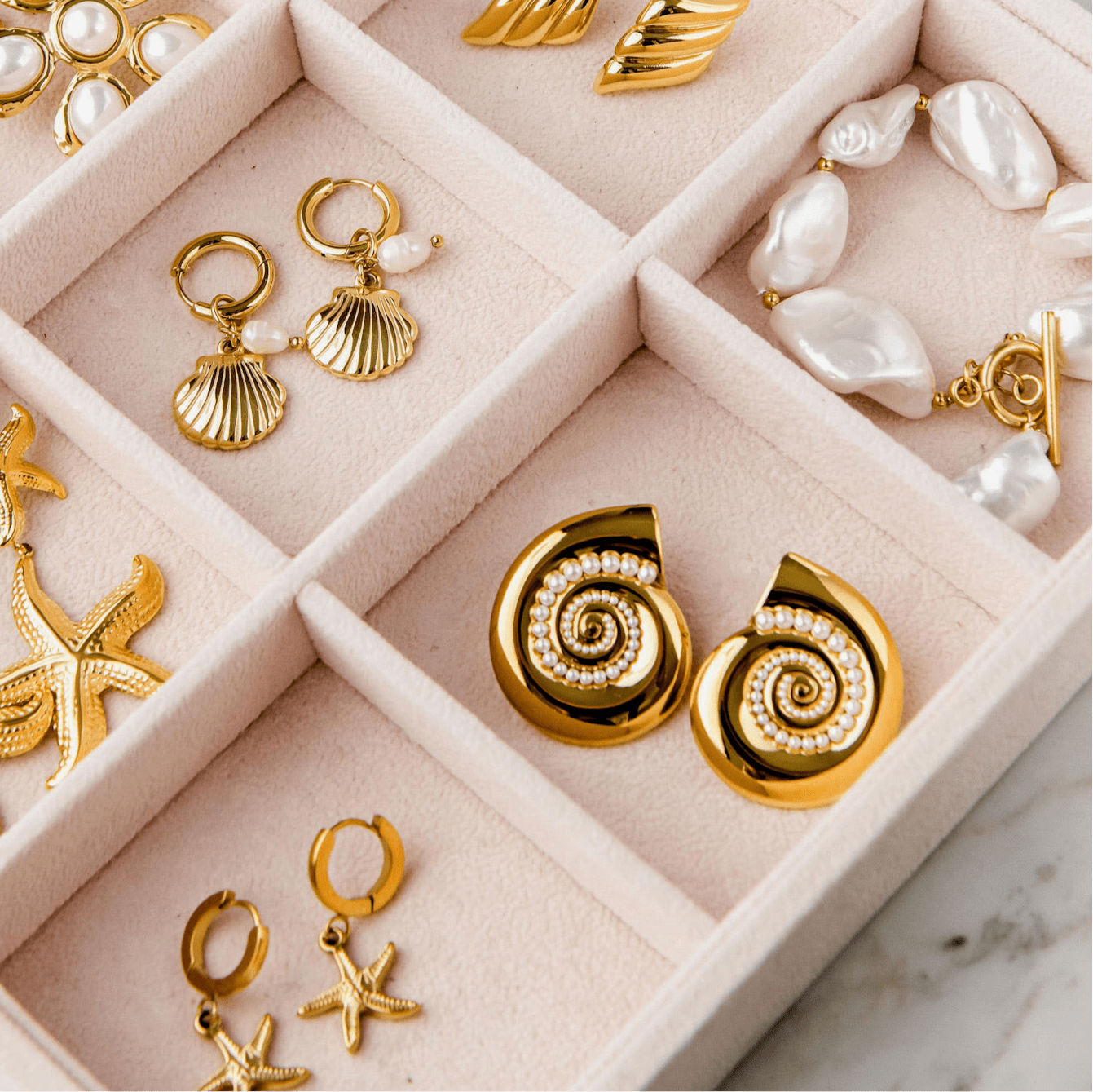 Paradiso Earrings with spiral gold shell design and pearl accents, gold statement earrings