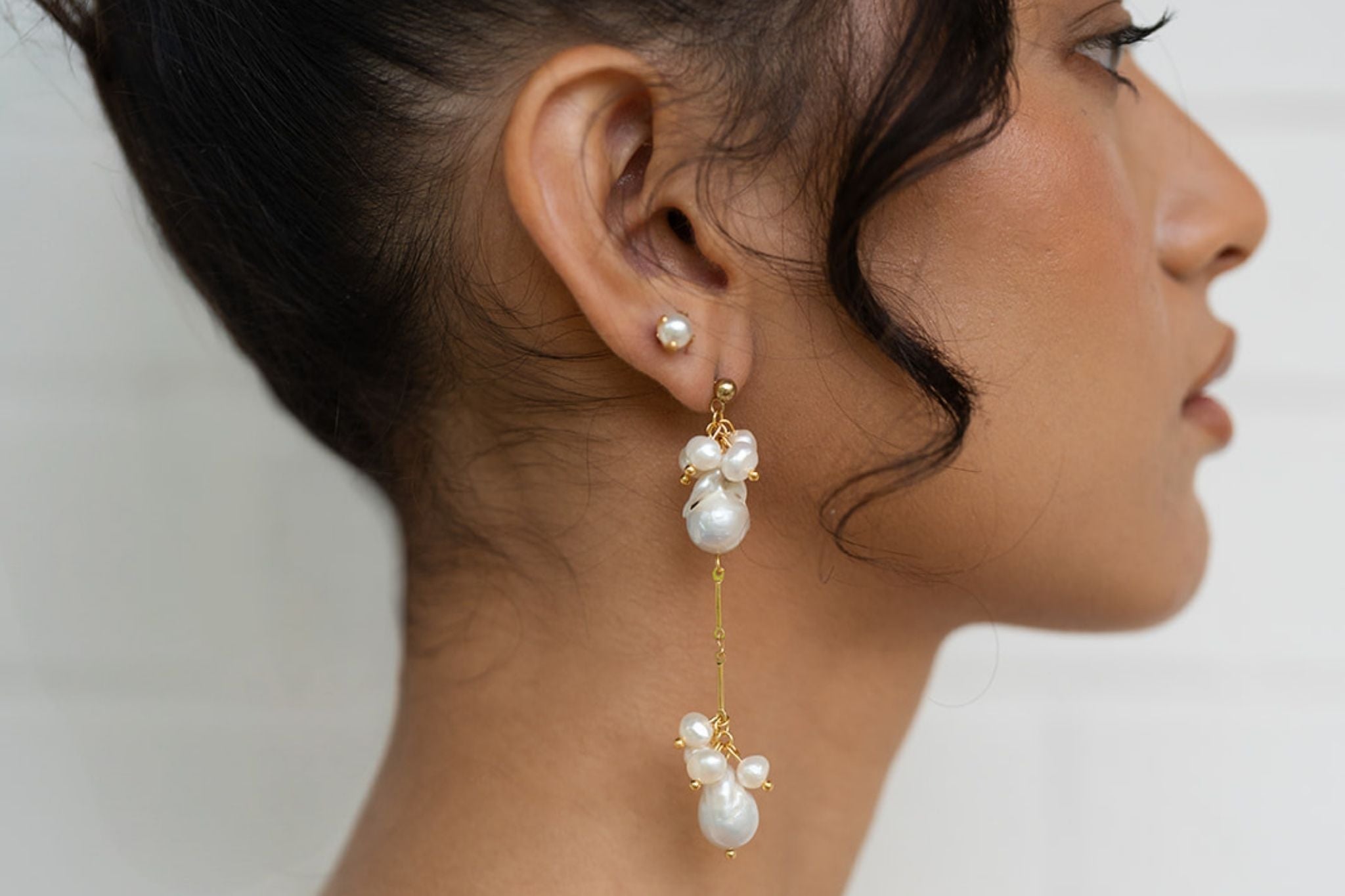 Waterproof gold pearl earrings made with freshwater pearls.