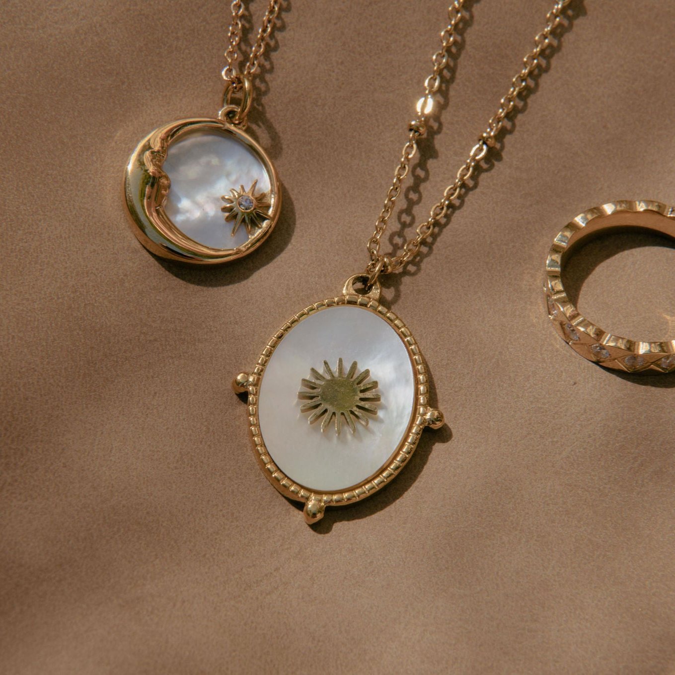 Gold sunburst pendant necklace with mother of pearl inlay and waterproof beaded frame
