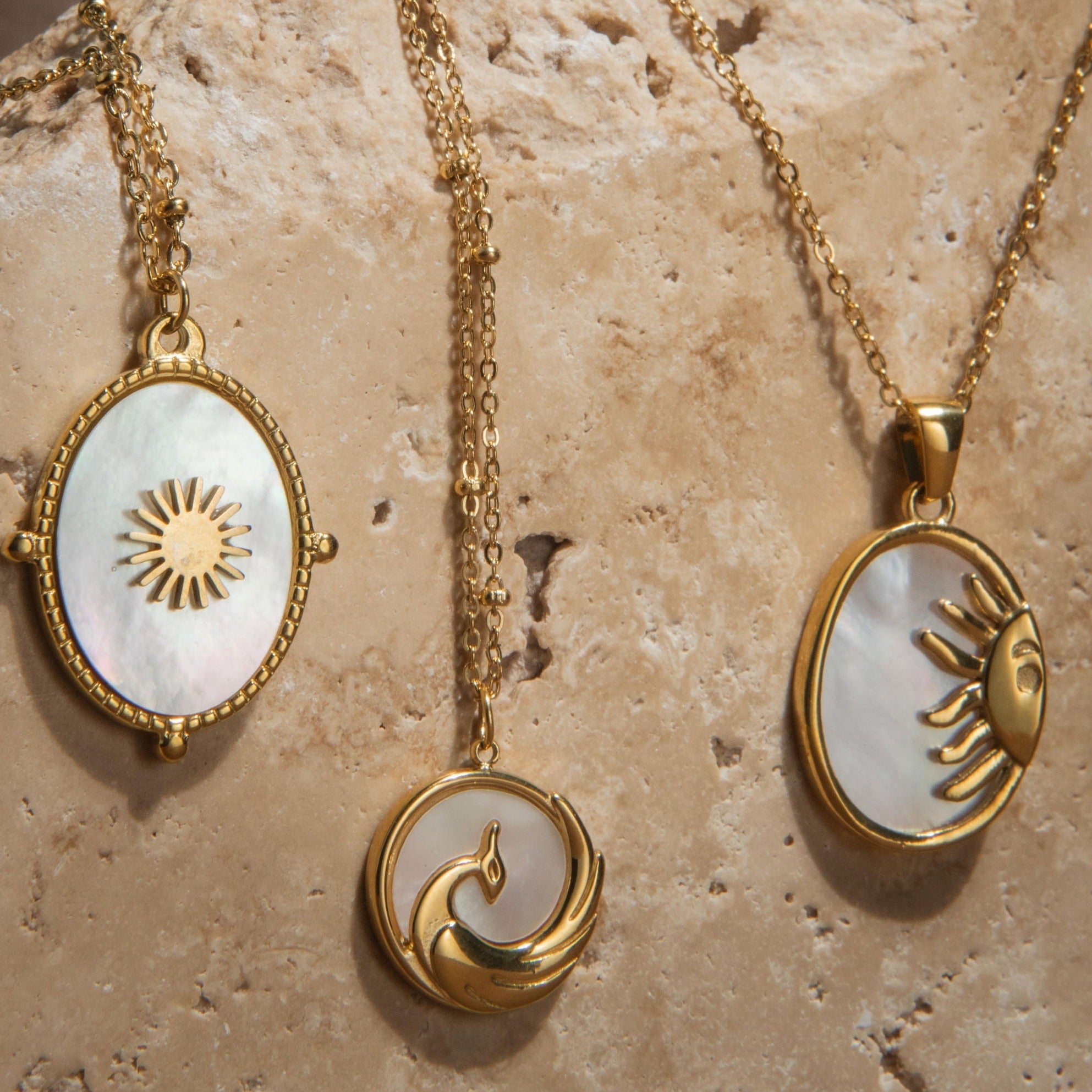 Gold pendant necklace with mother of pearl inlay and raised sun detail on a waterproof chain