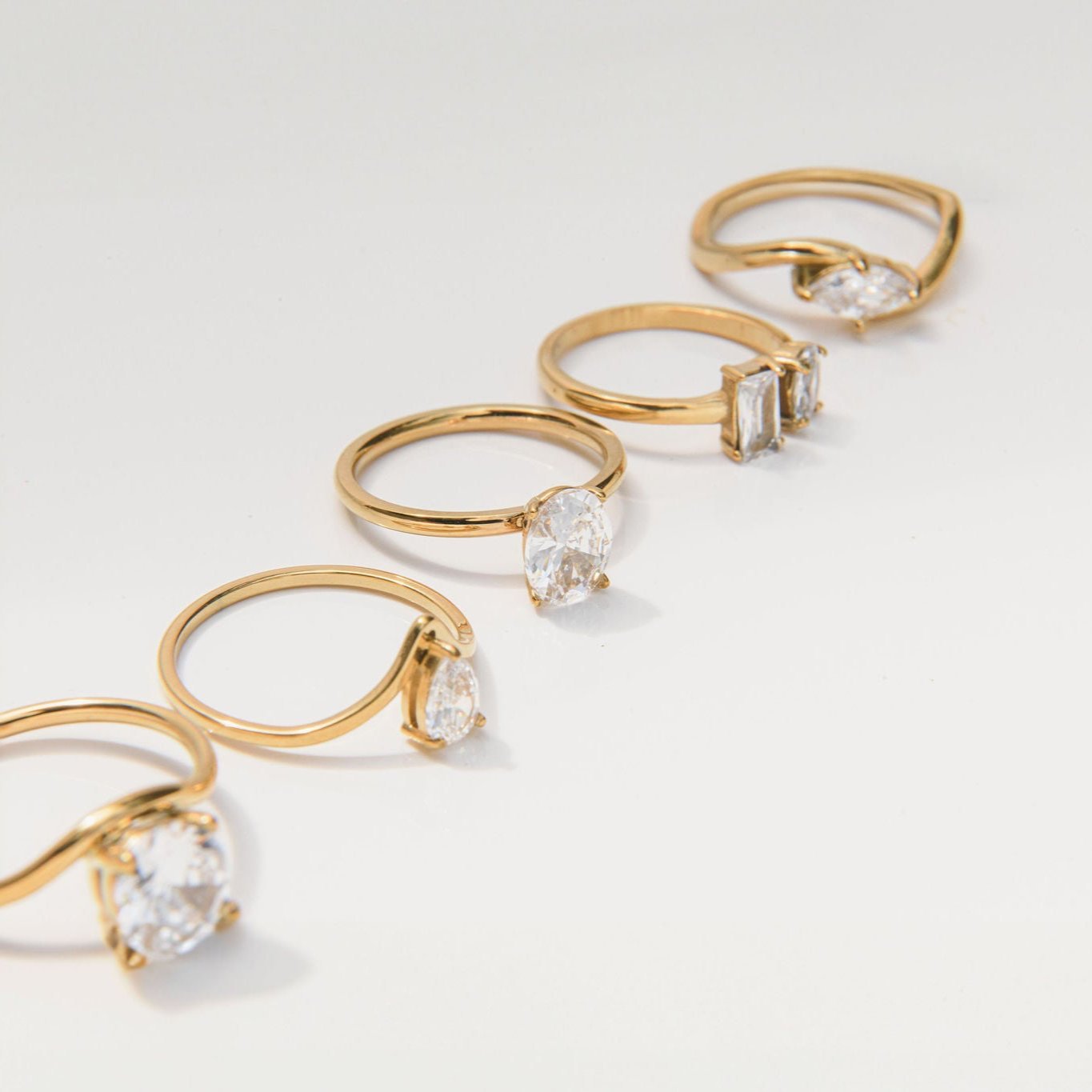 gold ring with marquise cut cubic zirconia and sculptural curved band