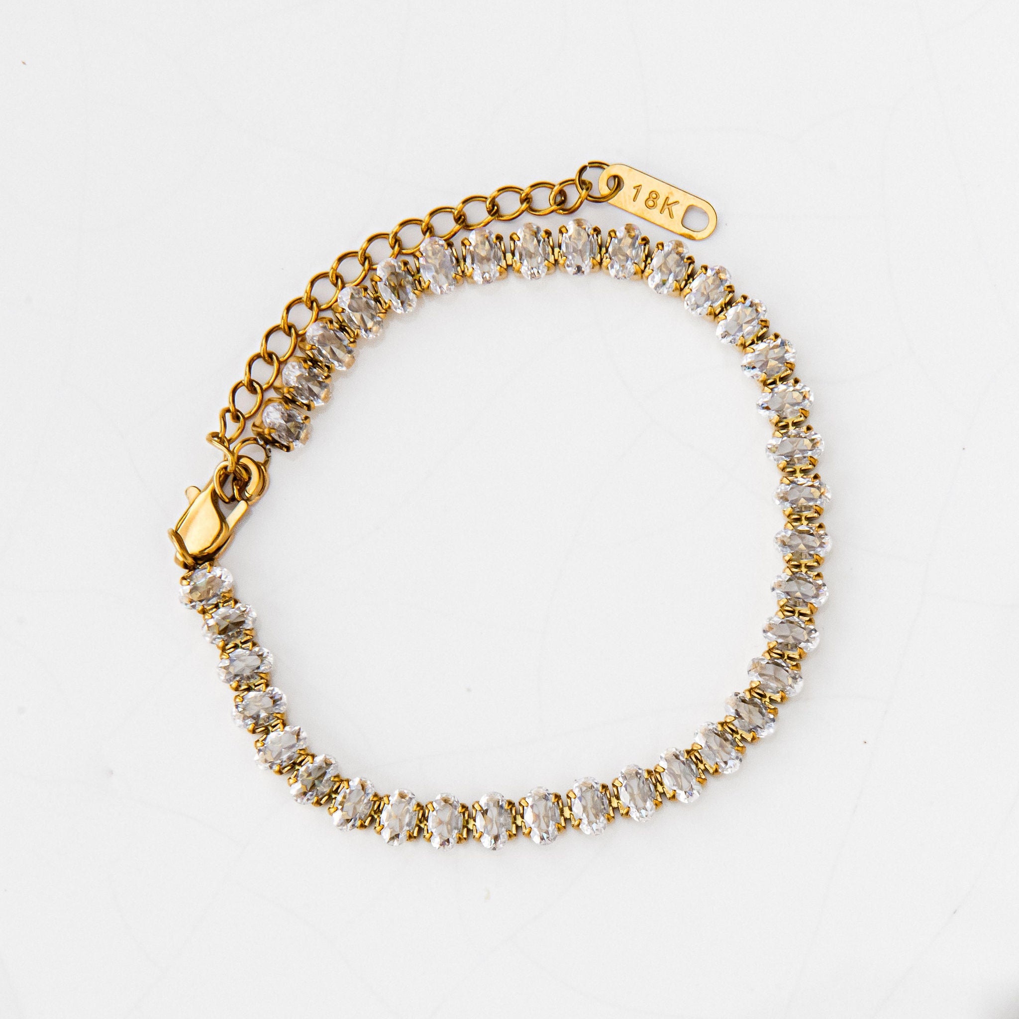 gold tennis bracelet with oval cubic zirconia stones for bridal or everyday wear