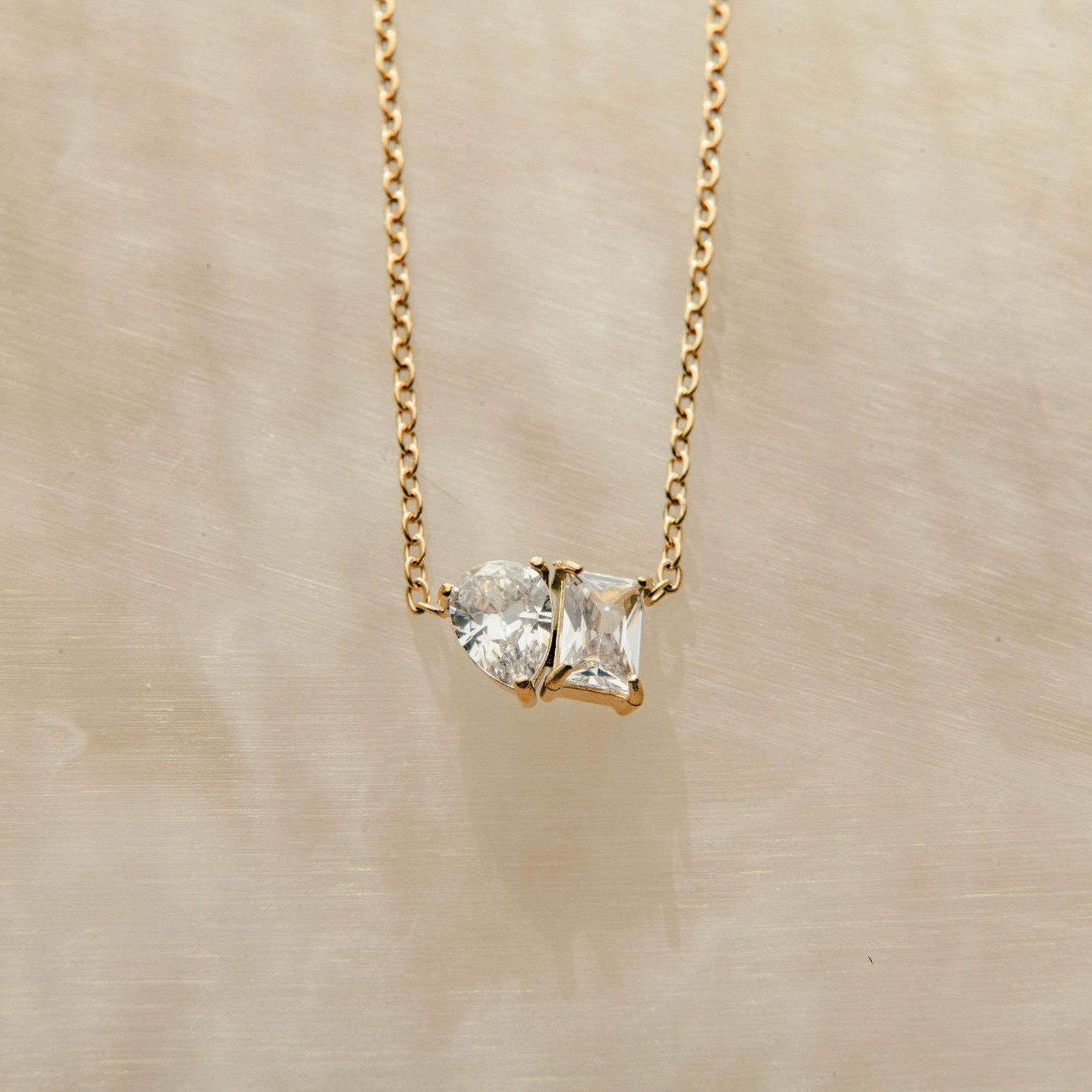 Toi et Moi gold necklace with pear and princess cut cubic zirconia stones