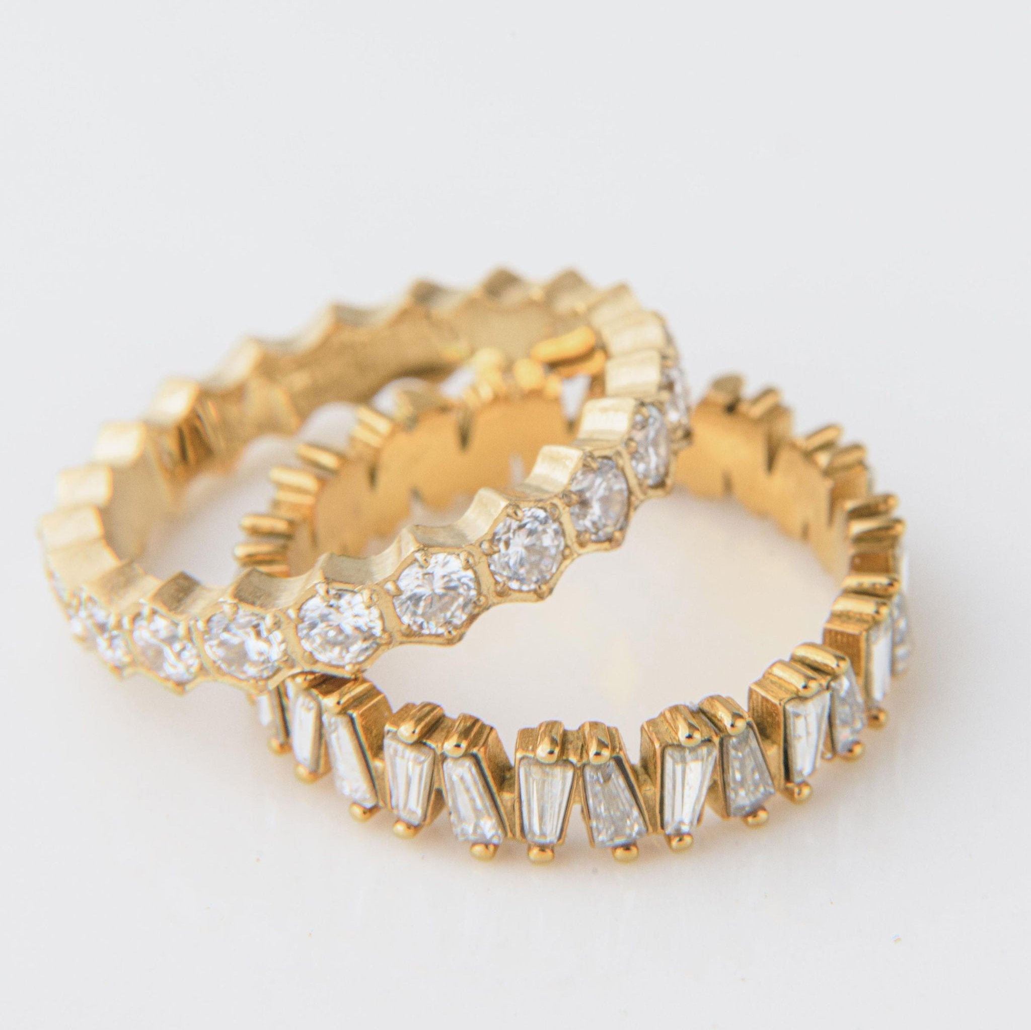 gold ring with baguette-cut Cubic Zirconia stones in a full band setting