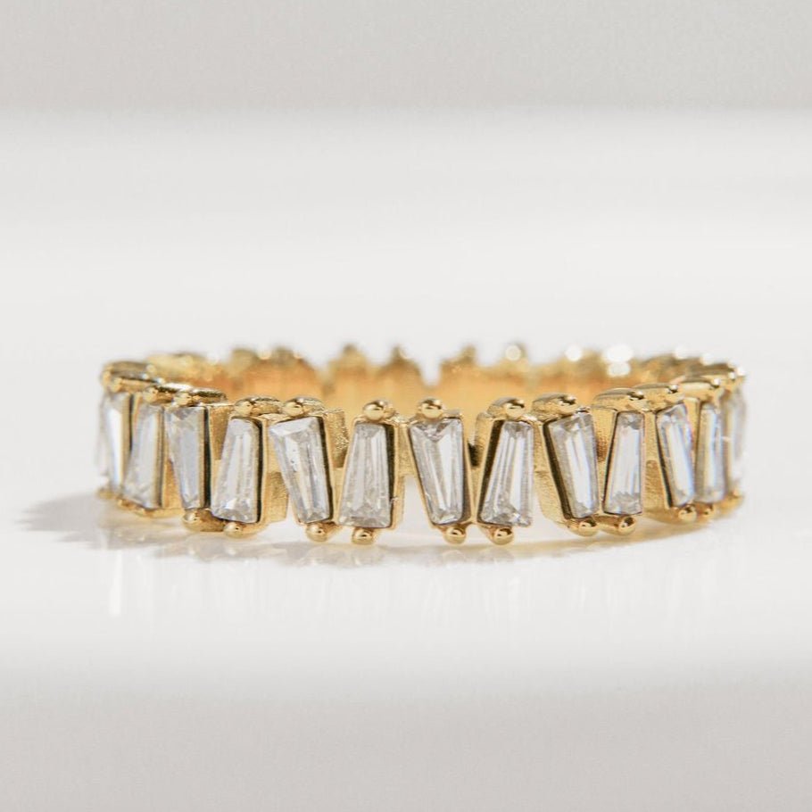 gold ring with baguette-cut Cubic Zirconia stones in a full band setting