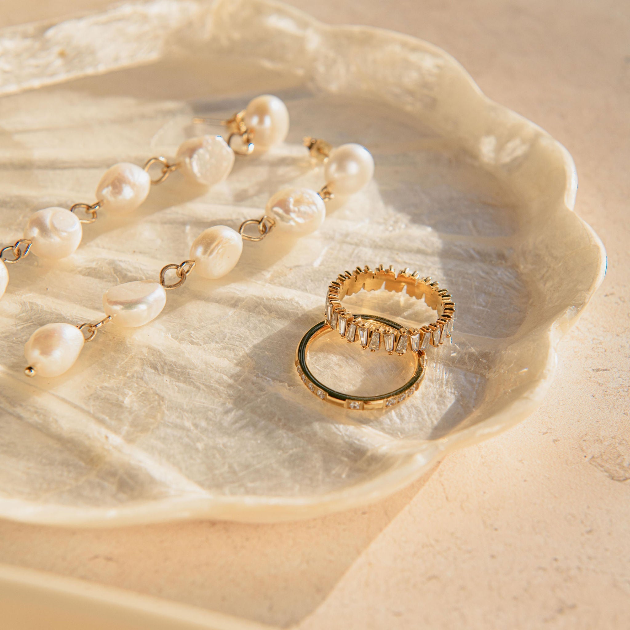 gold ring with baguette-cut Cubic Zirconia stones in a full band setting
