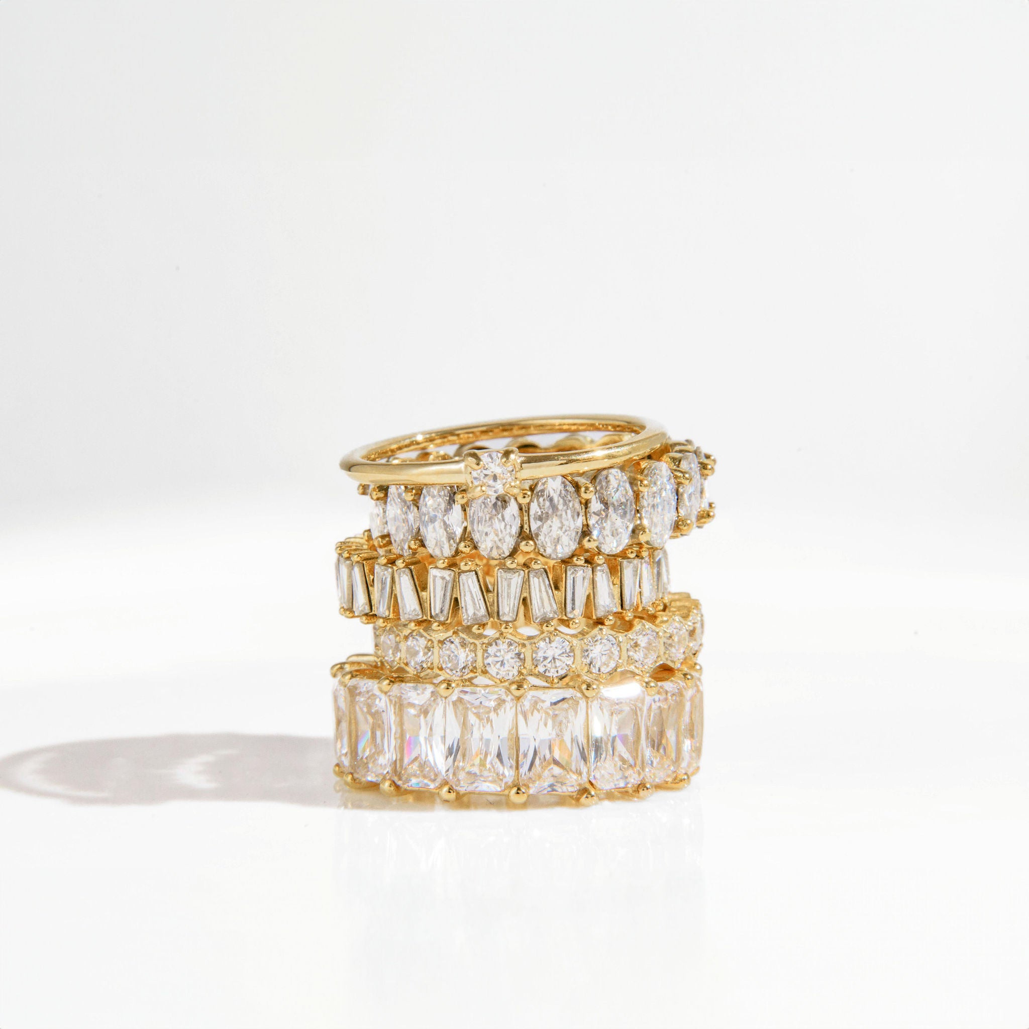 gold ring with baguette-cut Cubic Zirconia stones in a full band setting