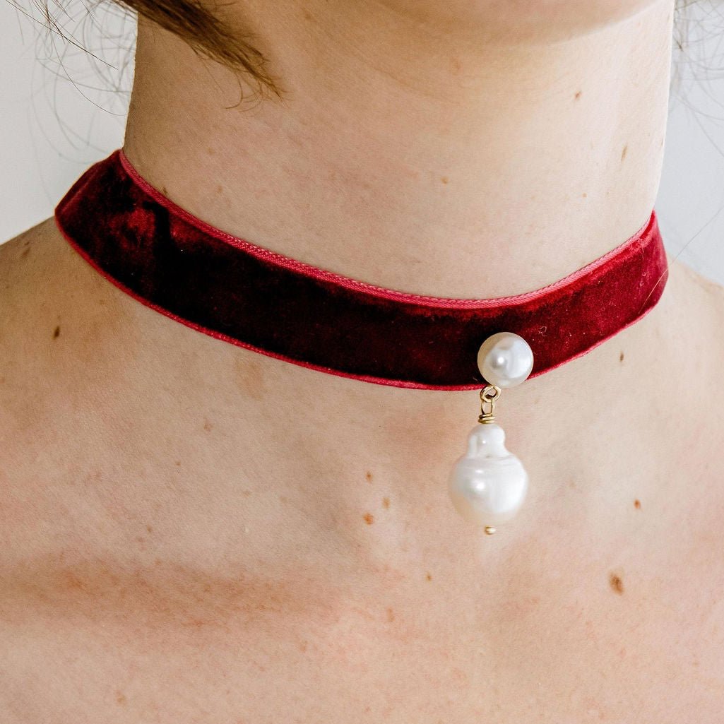 Velvet pearl choker with freshwater pearls and gold detail, tied in a bow for an adjustable fit
