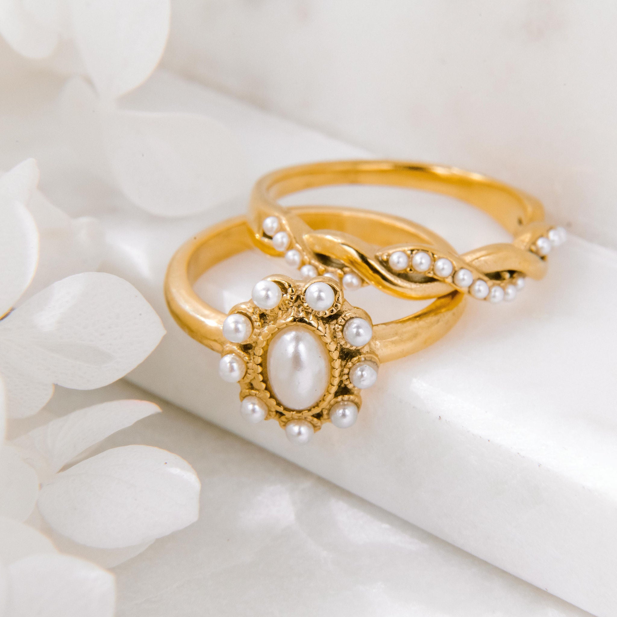 Gold pearl ring with oval freshwater pearl centre and small pearl accents in a waterproof setting