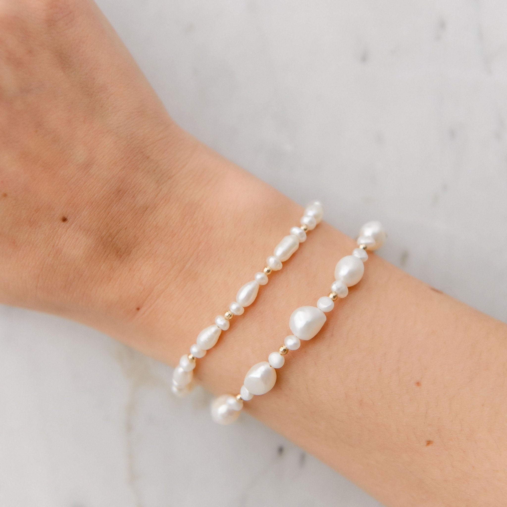 Ava Bracelet featuring organic freshwater pearls and gold bead accents on a waterproof gold chain