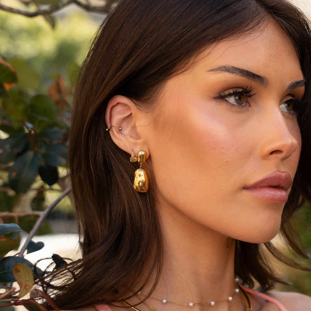 Capri gold stud earrings with polished organic-shaped drops