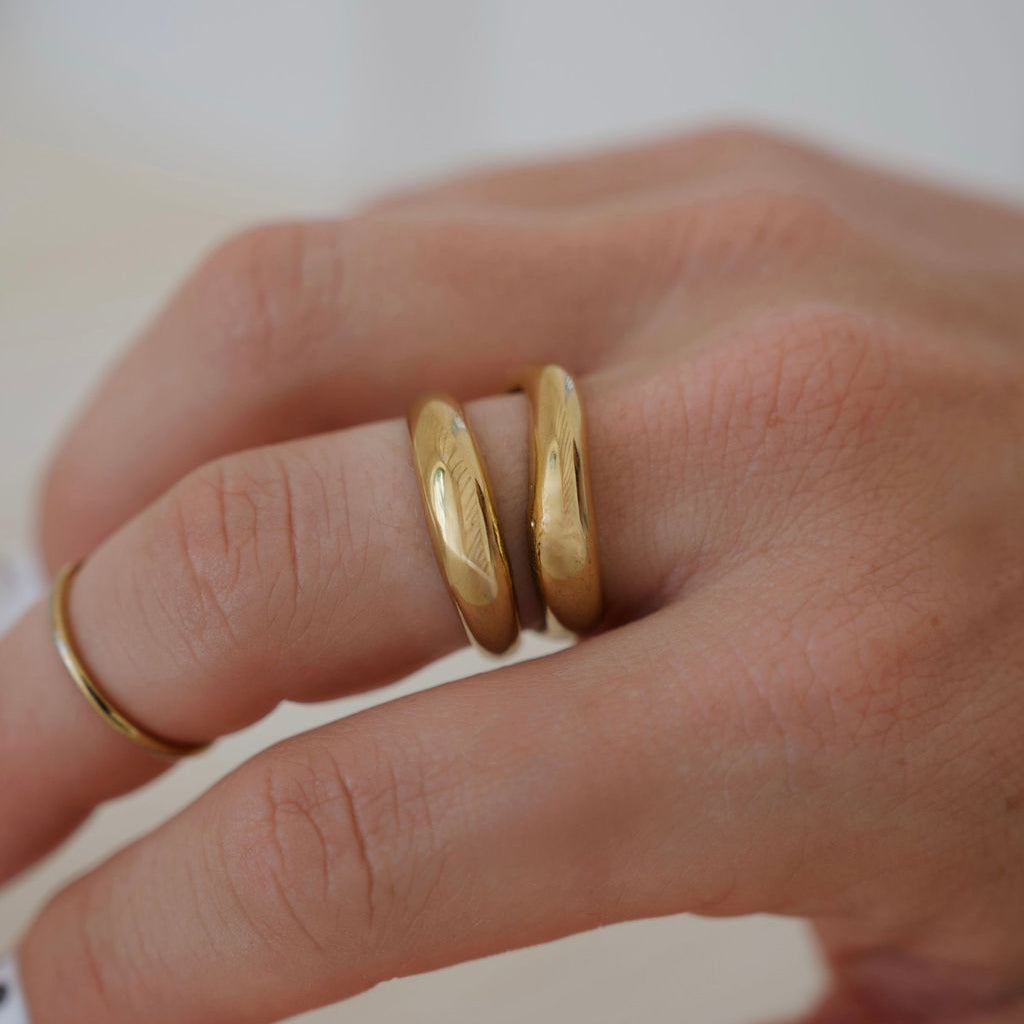 Cove sculptural gold statement ring with an open-front double-band design