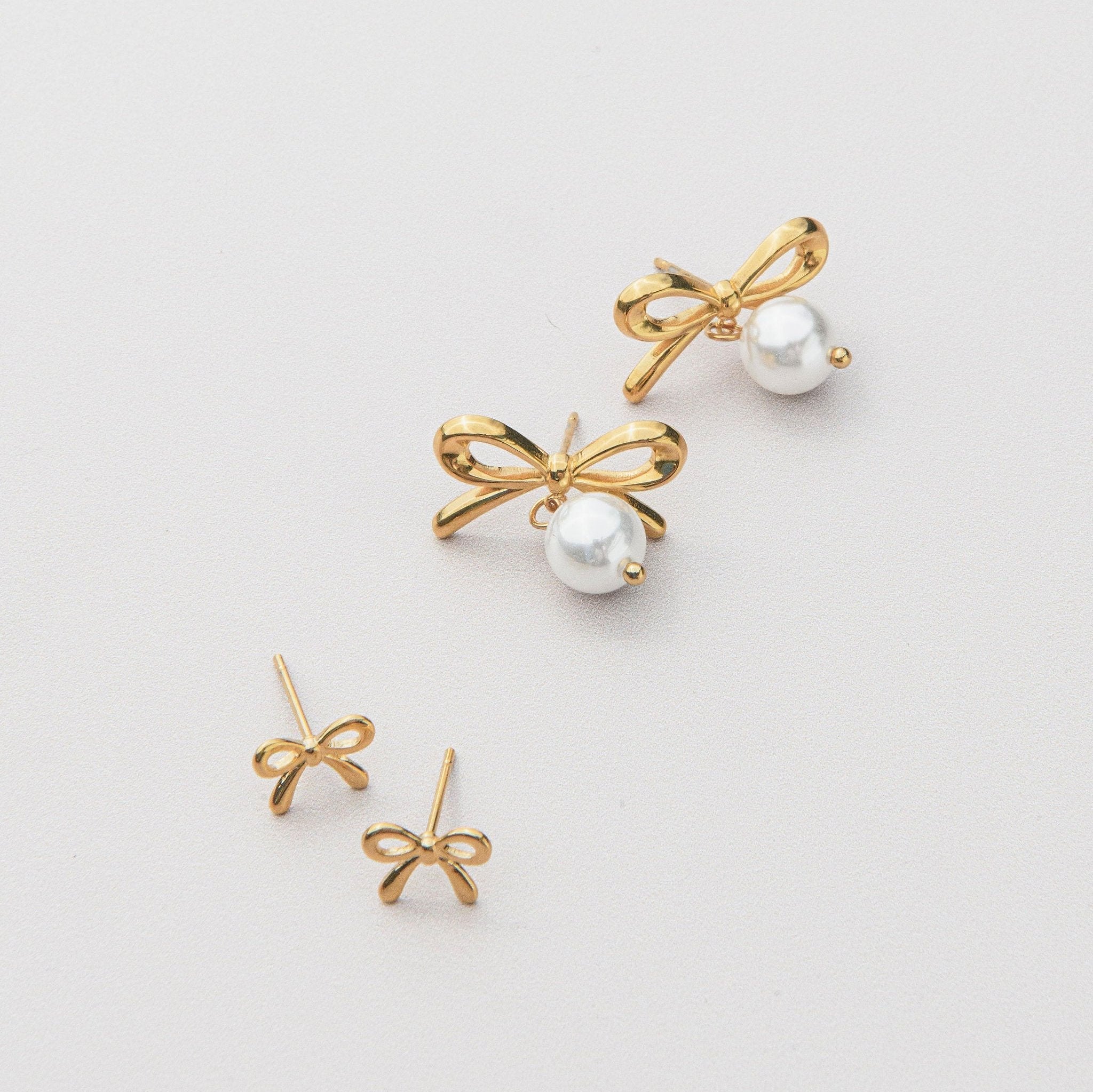 gold bow earrings with delicate stud earrings design