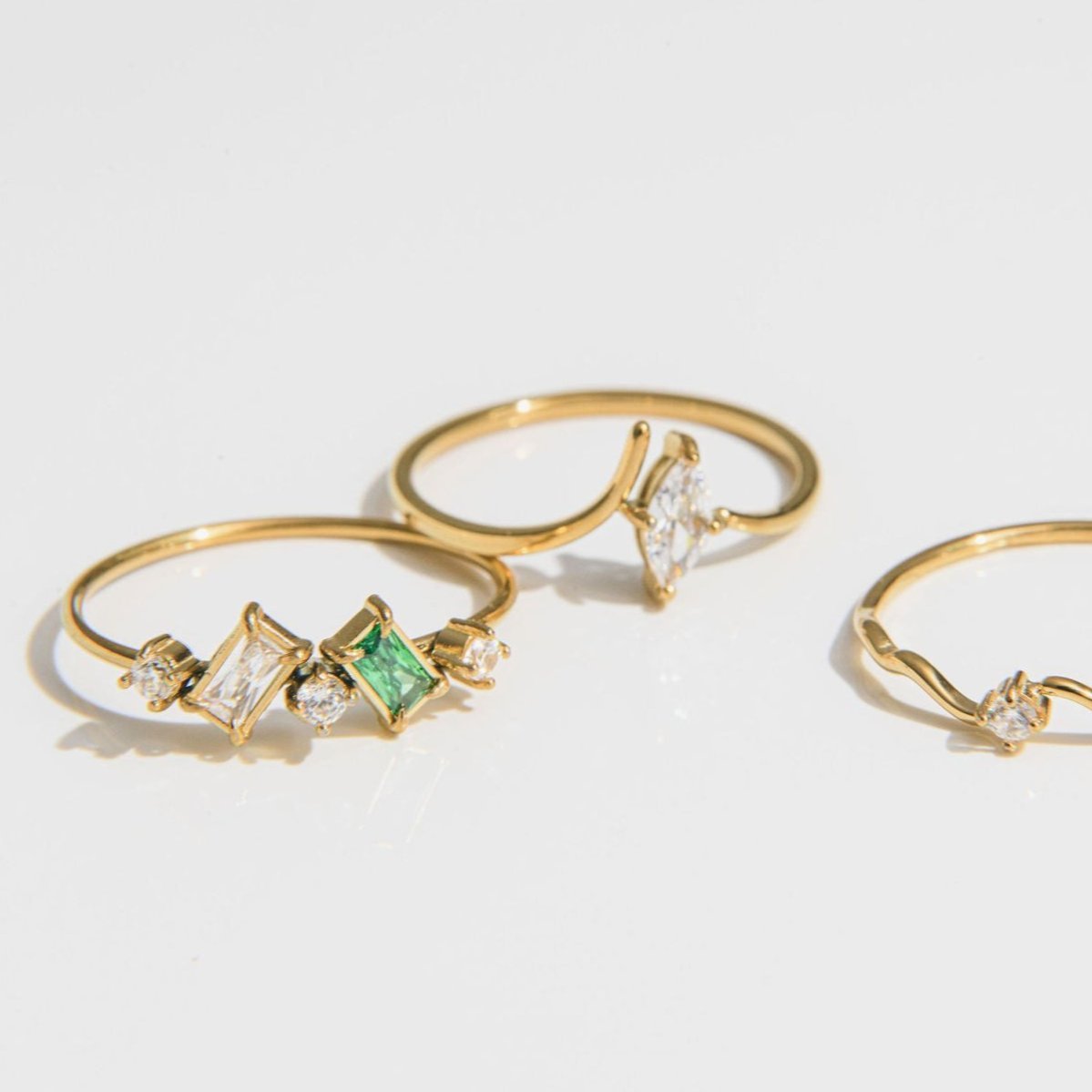 Gold bridal ring with green baguette and cubic zirconia stones