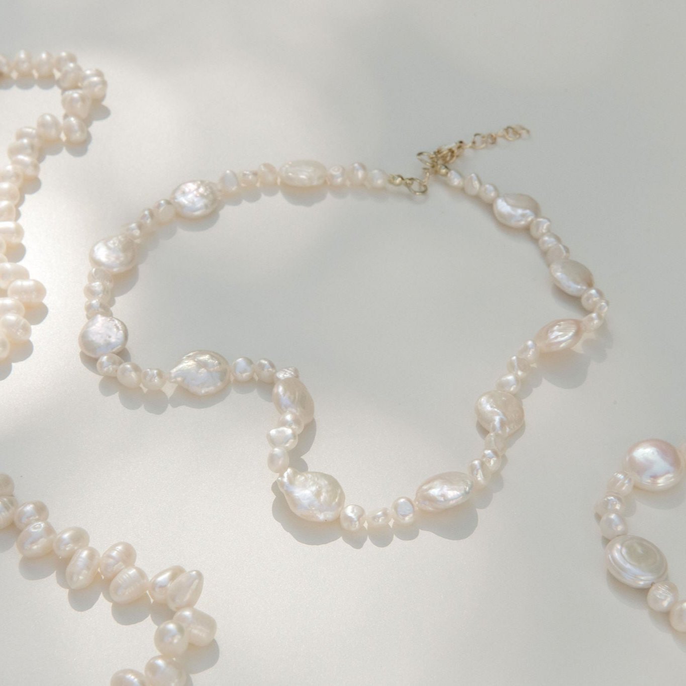 Freshwater pearl necklace featuring coin pearls and organic shapes with a waterproof gold clasp