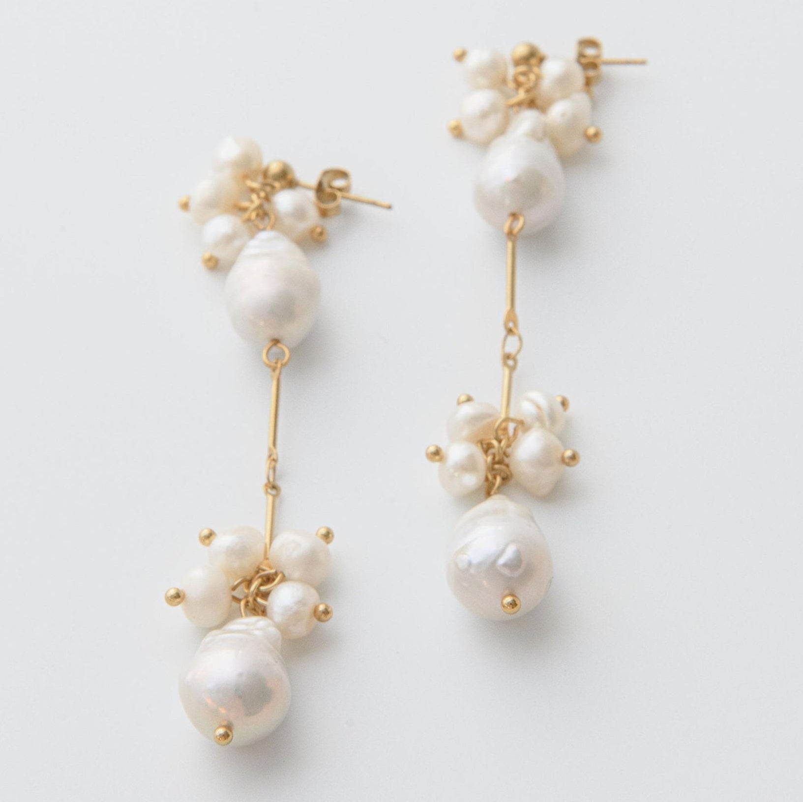 Gold pearl drop earrings with clustered freshwater pearls and waterproof gold stud setting for statement style