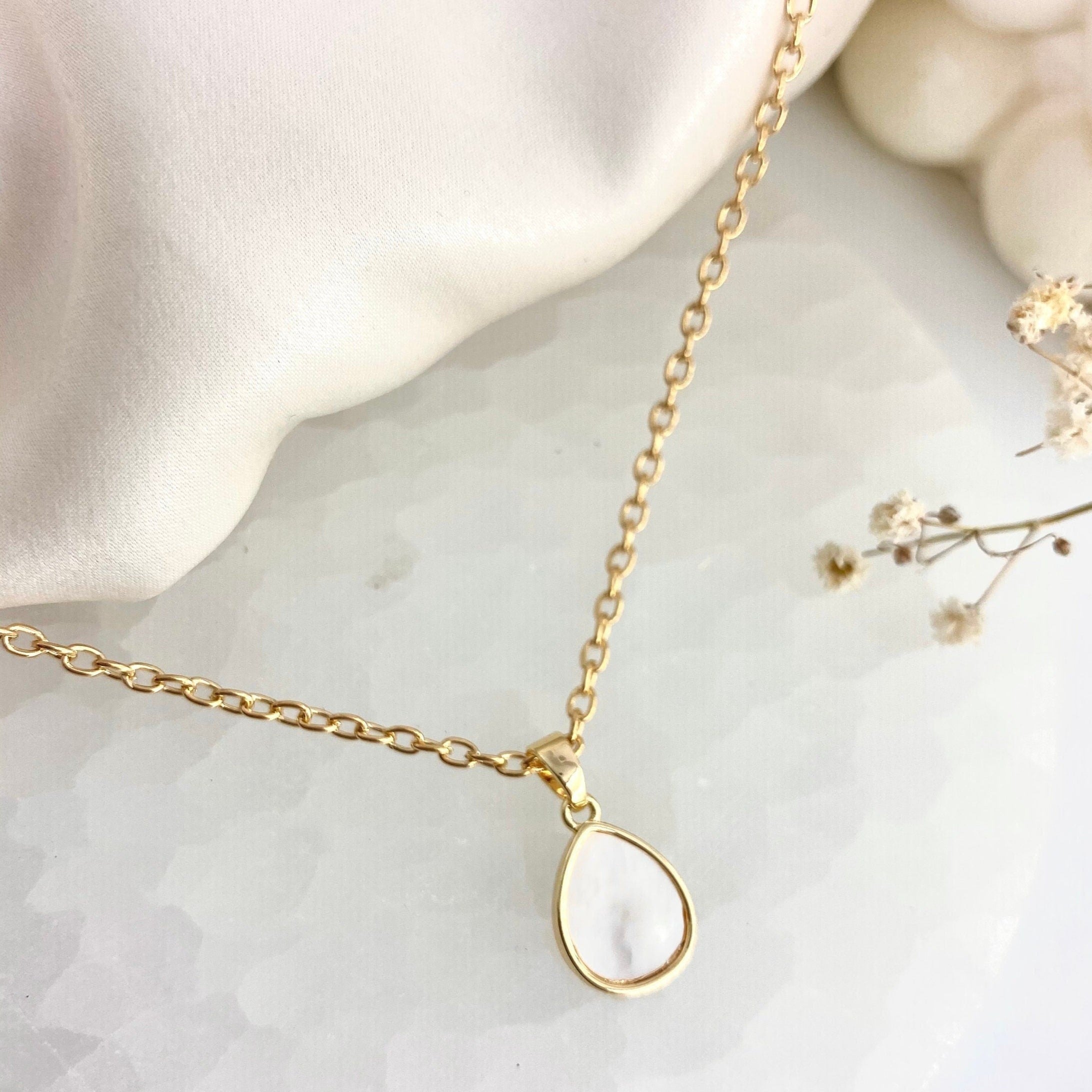 gold necklace with teardrop mother of pearl pendant